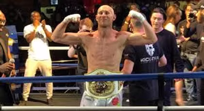 Jon Durrant celebrating victory in a boxing ring